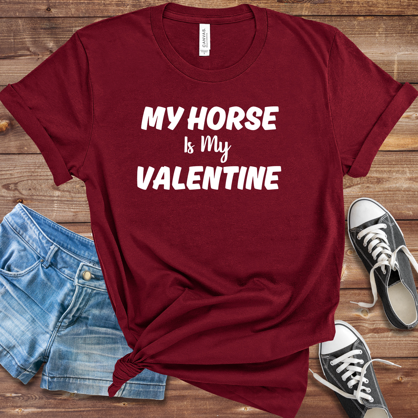 A person wearing a "My Horse Is My Valentine" maroon t-shirt, showcasing a stylish design, perfect for horse lovers and casual wear.