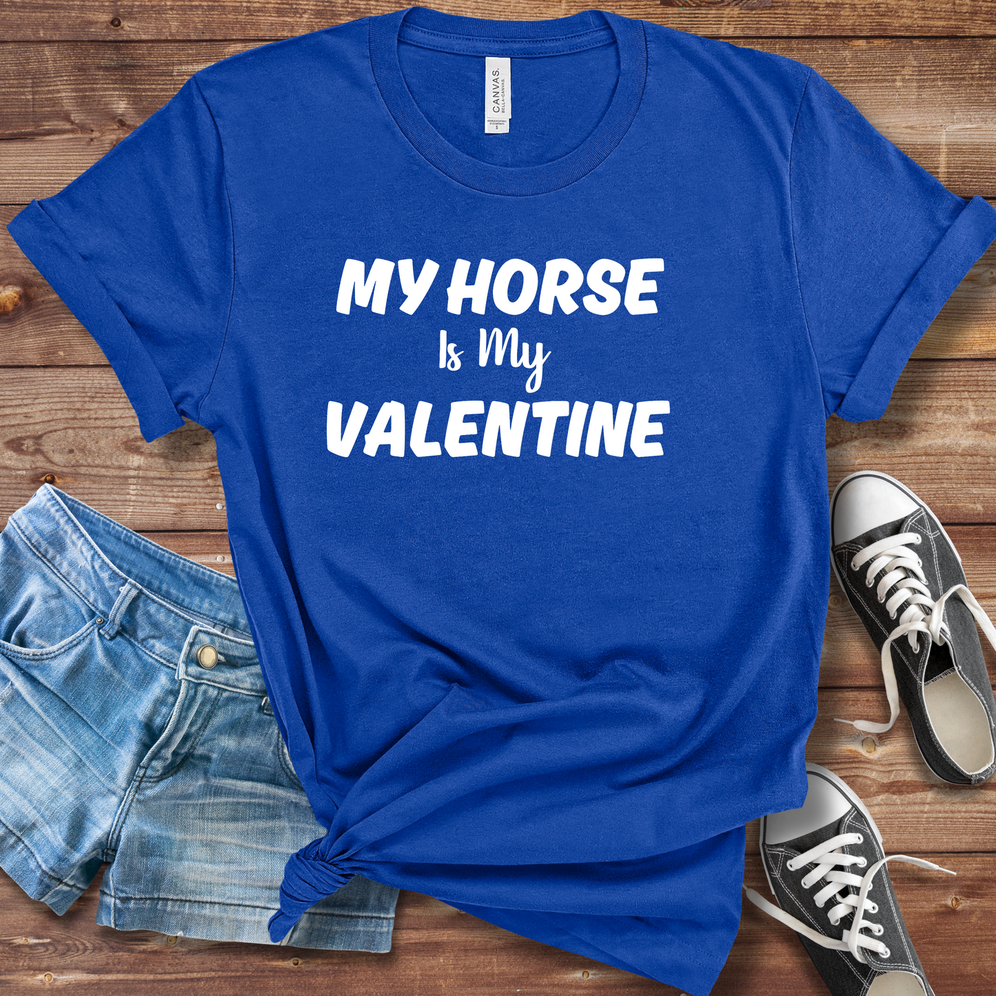 A person wearing a "My Horse Is My Valentine" royal blue t-shirt, showcasing a stylish design, perfect for horse lovers and casual wear.